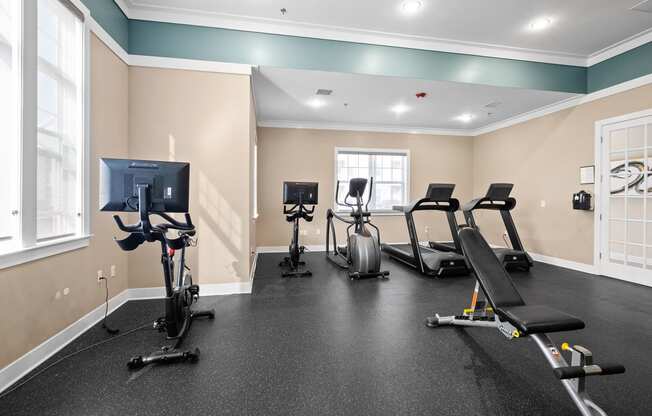 the gym with treadmills and exercise equipment at the enclave at woodbridge apartments