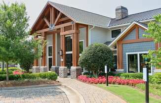 a home with a brick pathway leading to the front door