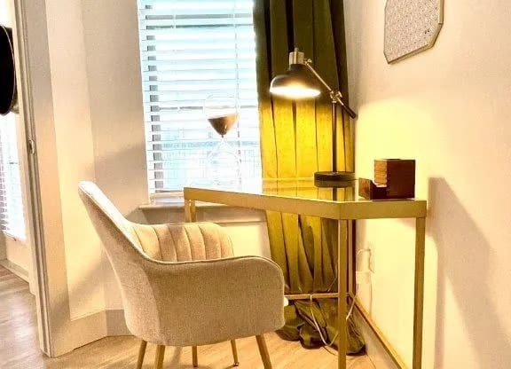a chair and a desk in a room with a window