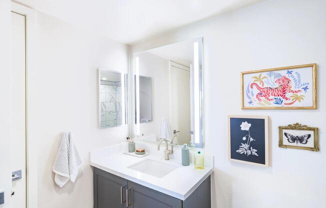 Experience luxury with designer bathrooms featuring quartz countertops and large mirrors!
