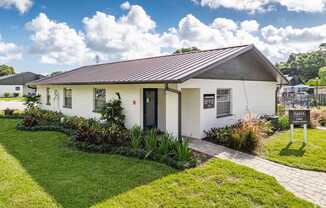 A white house with a red roof and a sign that says Paris.