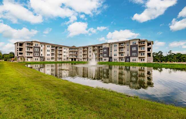 a large pond in front of an apartment building