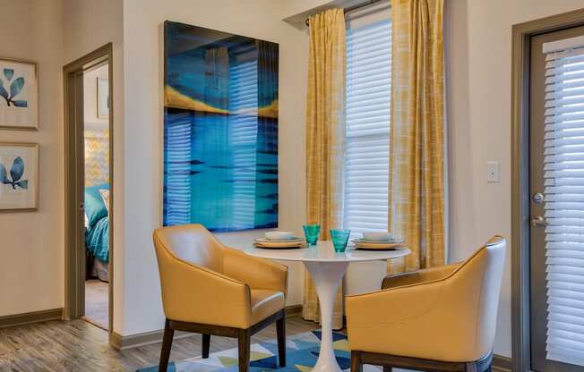 corner of living room space with coffee table and chairs at Parc at Bentonville Apartments in Bentonville, AR