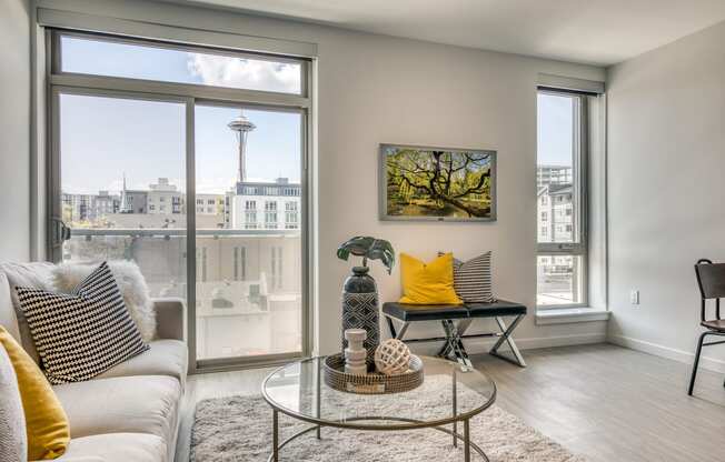 a living room with a large window and a couch and a table