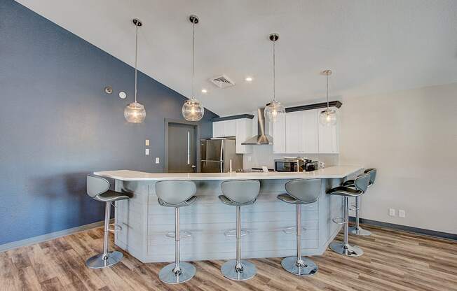 a kitchen with an island and stools