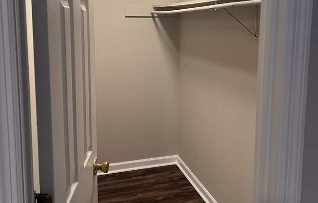 a small room with a closet and a door