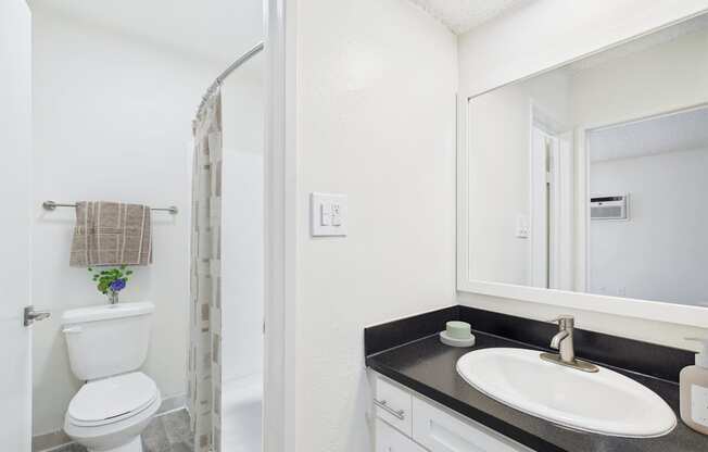 A patio with a pool and chairs.