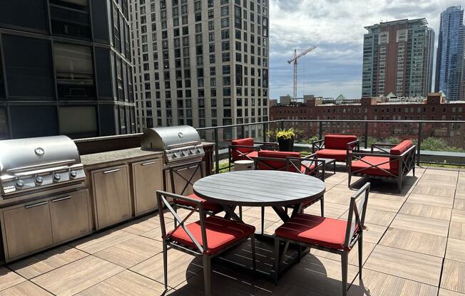 a patio with a table and chairs on a rooftop