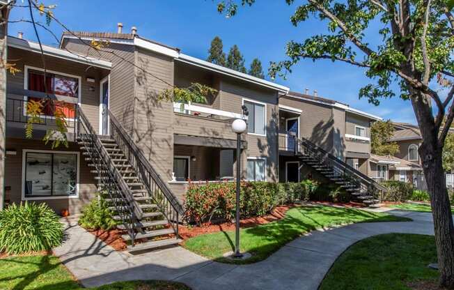 Pet Friendly Apartments in Morgan Hill CA - Monte Vista - Building Exteriors with Stairs, Greenery, and Pathway