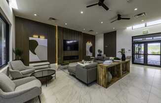 a living room with couches and chairs and a tv the gym  at a residential apartment community Resia in Decatur GA