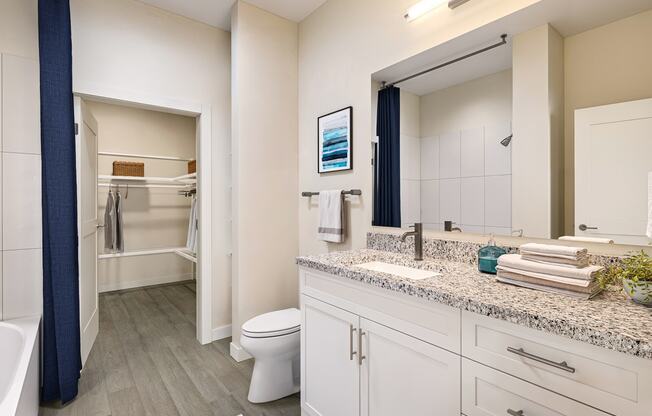 a bathroom with a  large mirror and a toilet and a shower