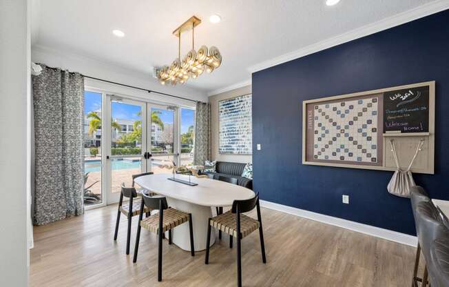 a dining room with a table and chairs and a chandelier