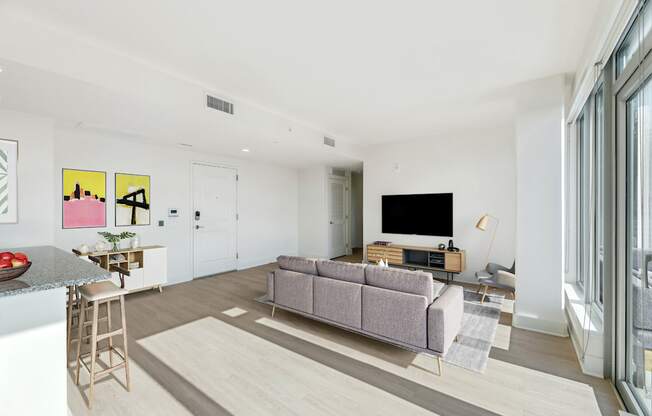 a living room with a couch and a tv  at Link Apartments® H Street, Washington, DC