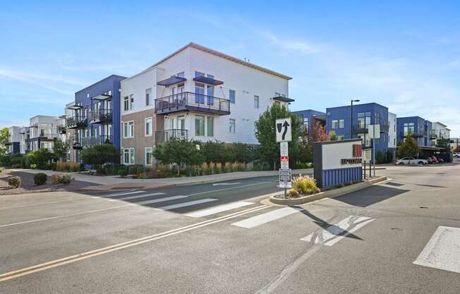 A modern apartment complex with a clear blue sky above.