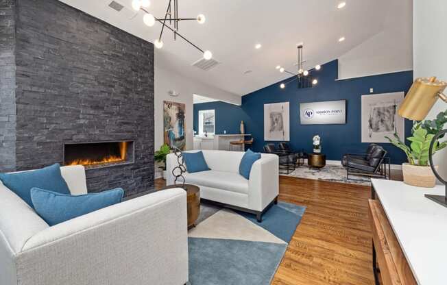 addison point interior resident lounge with blue and white furniture and a fireplace