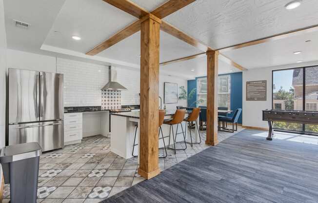 an open kitchen and dining area with a bar and a pool table