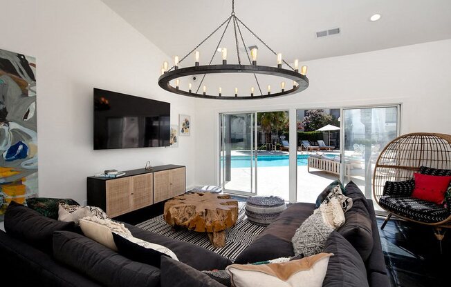 Clubhouse with Grey Sectional Couch, Modern Hanging Chandelier, and Pool Access at Laurel Creek, Fairfield, California