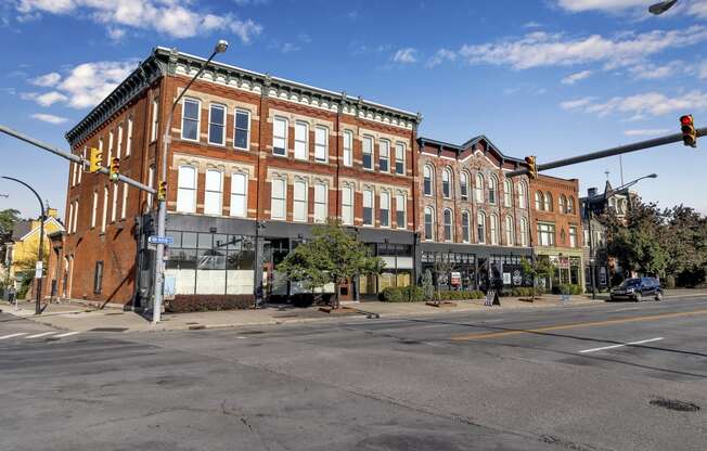 a large brick building on the corner of a city street at The Granite Works Apartments , Buffalo, NY