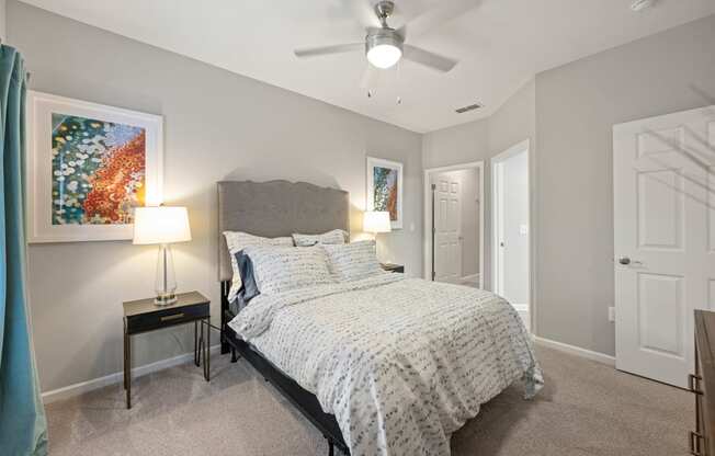 a bedroom with a bed and a ceiling fan