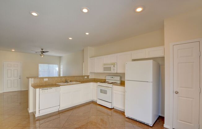 Beautiful two bedroom in great location. Step through the front door into a sun-filled great room featuring oversized tile flooring, recessed lighting, and a modern ceiling fan. Large windows and a glass slider invite natural light and frame the connectio