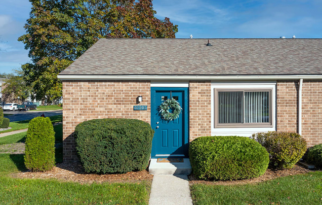 our apartments showcase a beautiful brick building with a blue front door