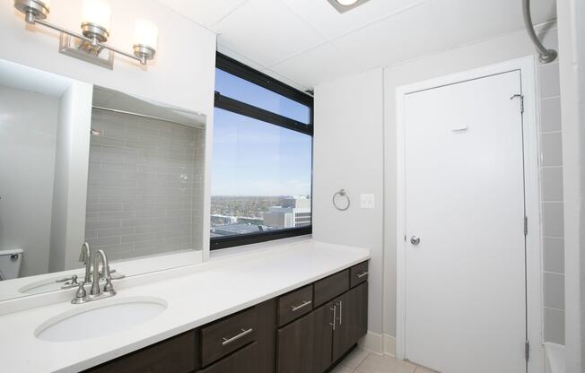a bathroom with a sink and a window at Apartments at Denver Place, Colorado