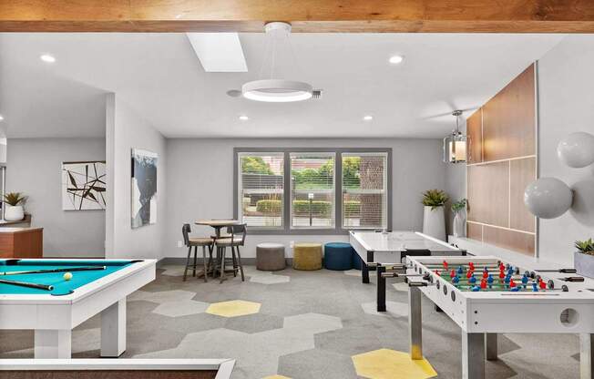 A room with a pool table and a foosball table. at Northpoint Apartments, Washington