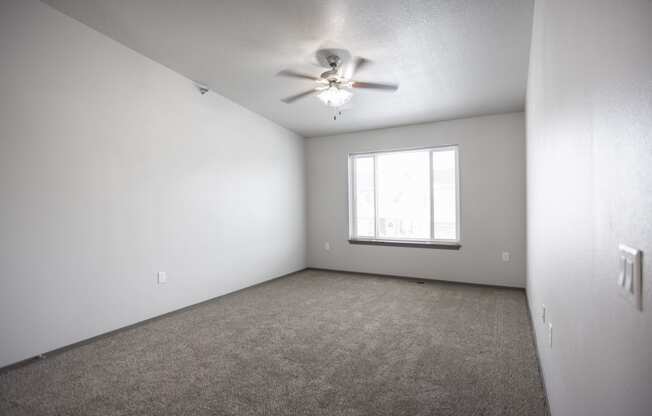 Unfurnished bedroom featuring vaulted ceilings and a walk-in closet.