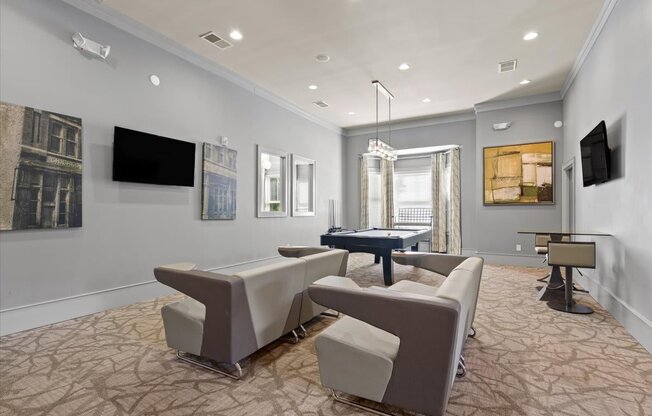 a living room with couches and a ping pong table