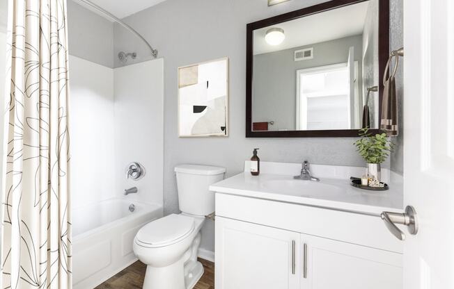 Reserve at Providence Apartment in Charlotte NC photo of a bathroom with a white toilet next to a white bathtub and a white sink