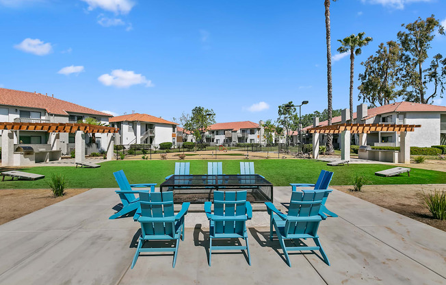 Apartments for Rent Moreno Valley - Ardella on Chagall - BBQ Area with Grilling Stations Under Pergolas, Manicured Grass Lawn, Cornhole Boards, Table and Chairs