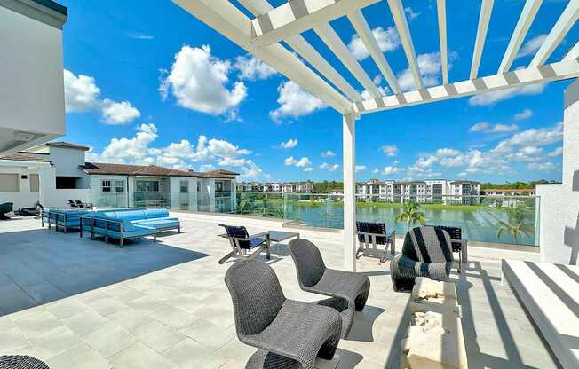 Partially shaded rooftop terrace with TVs, kitchen and bar