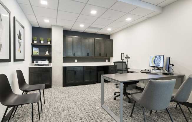 an office space with a desk and chairs and a computer