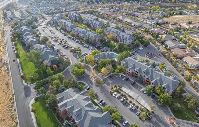 an aerial view of a neighborhood with houses and cars parked on the street