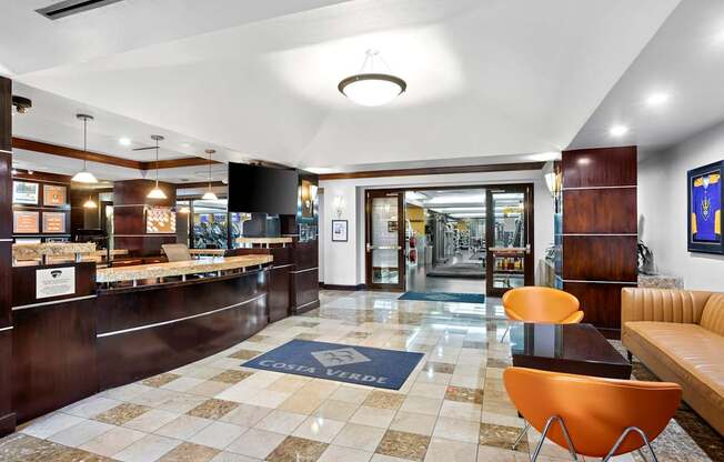A reception area with a checkered floor and a blue and white rug.