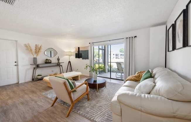 a living room with a white couch and a sliding glass door