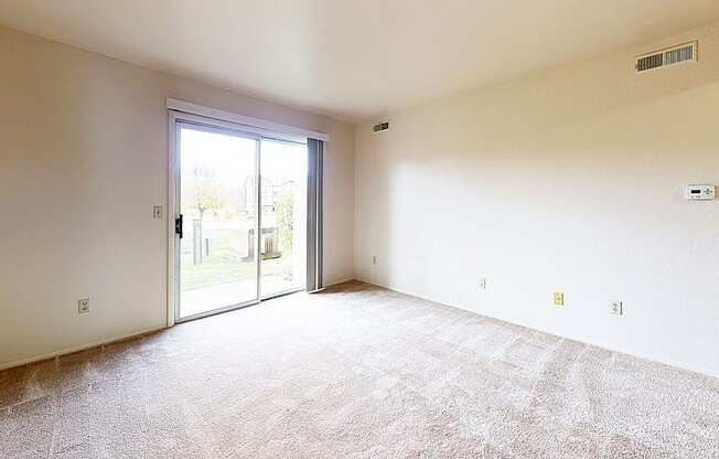 living room with a sliding glass door to a private patio
