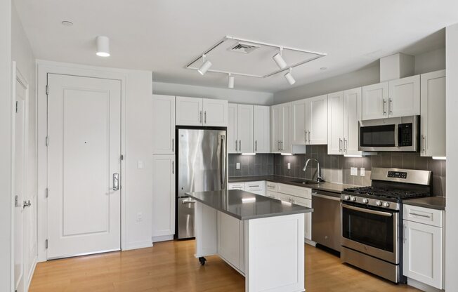 Beautifully decorated kitchen with white furniture at Park77 Apartments, Cambridge, 02138