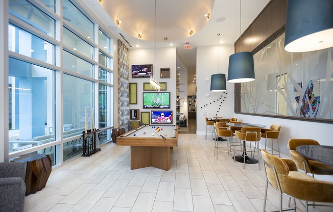 Game room with TVs, pool table, and lounge style seating at Residences at The Green
