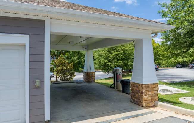 a carport with a driveway in front of a house