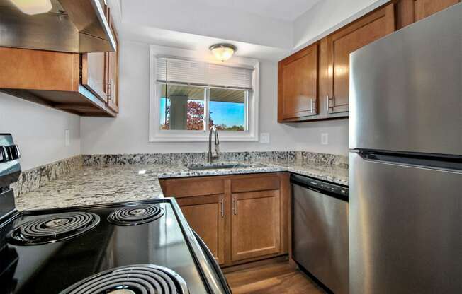 a kitchen with stainless steel appliances and granite counter tops