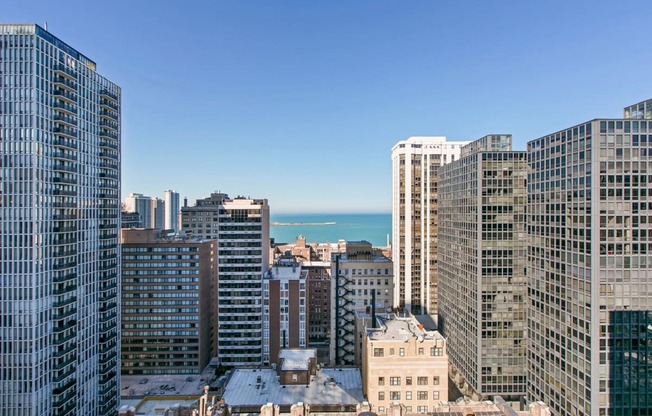 a view of the city skyline and the ocean from a skyscraper