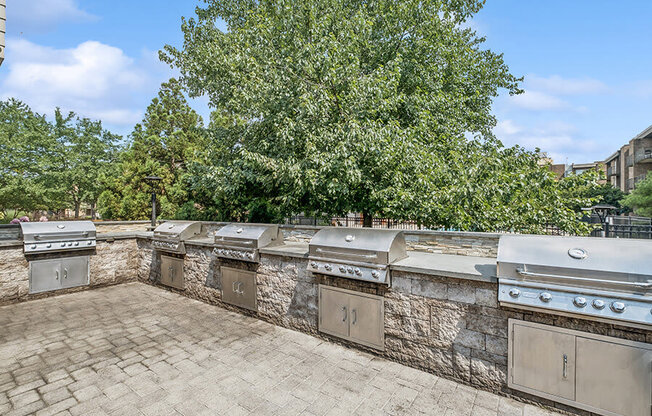 Outdoor BBQ Area with Five Grills at Mason Van Dorn Apartments located in Alexandria, VA.