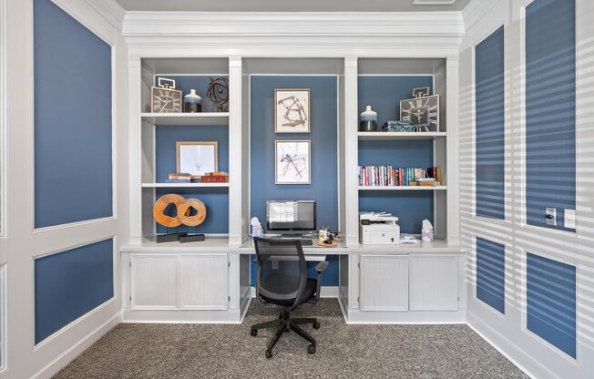 A room with a desk and a chair in front of a wall with shelves. at Crescent Apartment Homes, Lenexa, 66219