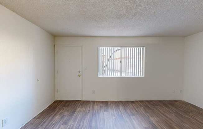 the spacious living room with wood flooring and a window at La Terraza, Phoenix, 85018