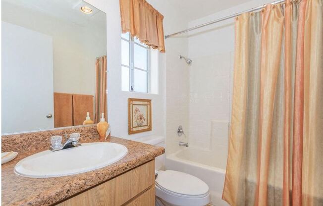 a bathroom with a sink and a toilet and a shower at Riverview Springs, Oceanside, California