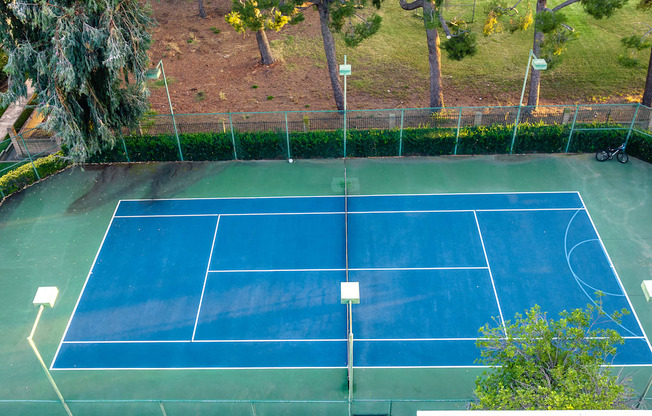 Two-Bedroom Apartments in Alta Loma, CA - Woodbend - Tennis Court with Fenced-in Area and Trees at Woodbend, Alta Loma, 91701