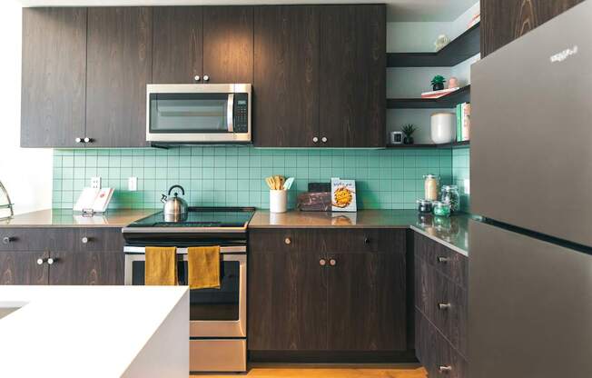 A kitchen with a stove, oven, and refrigerator.