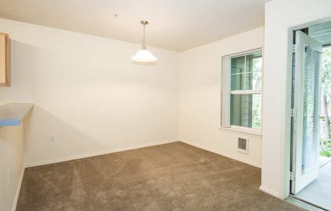 a bedroom with a carpeted floor and an open door to a patio