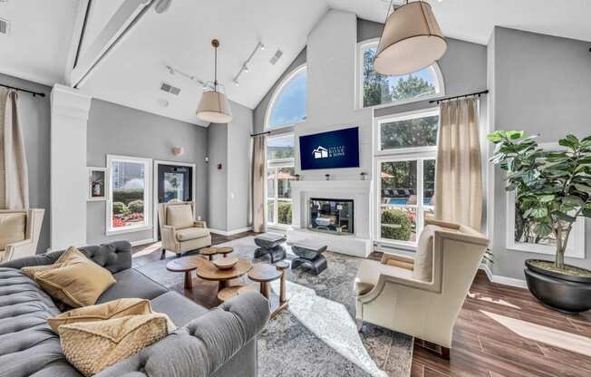 a living room with a couch and chairs and a fireplace